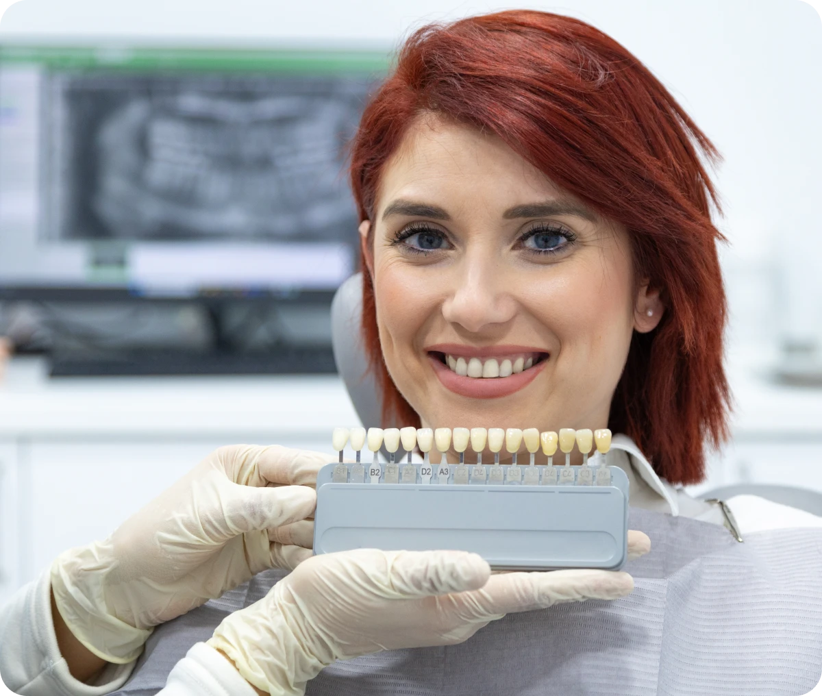 Woman smiling with dental shade guide