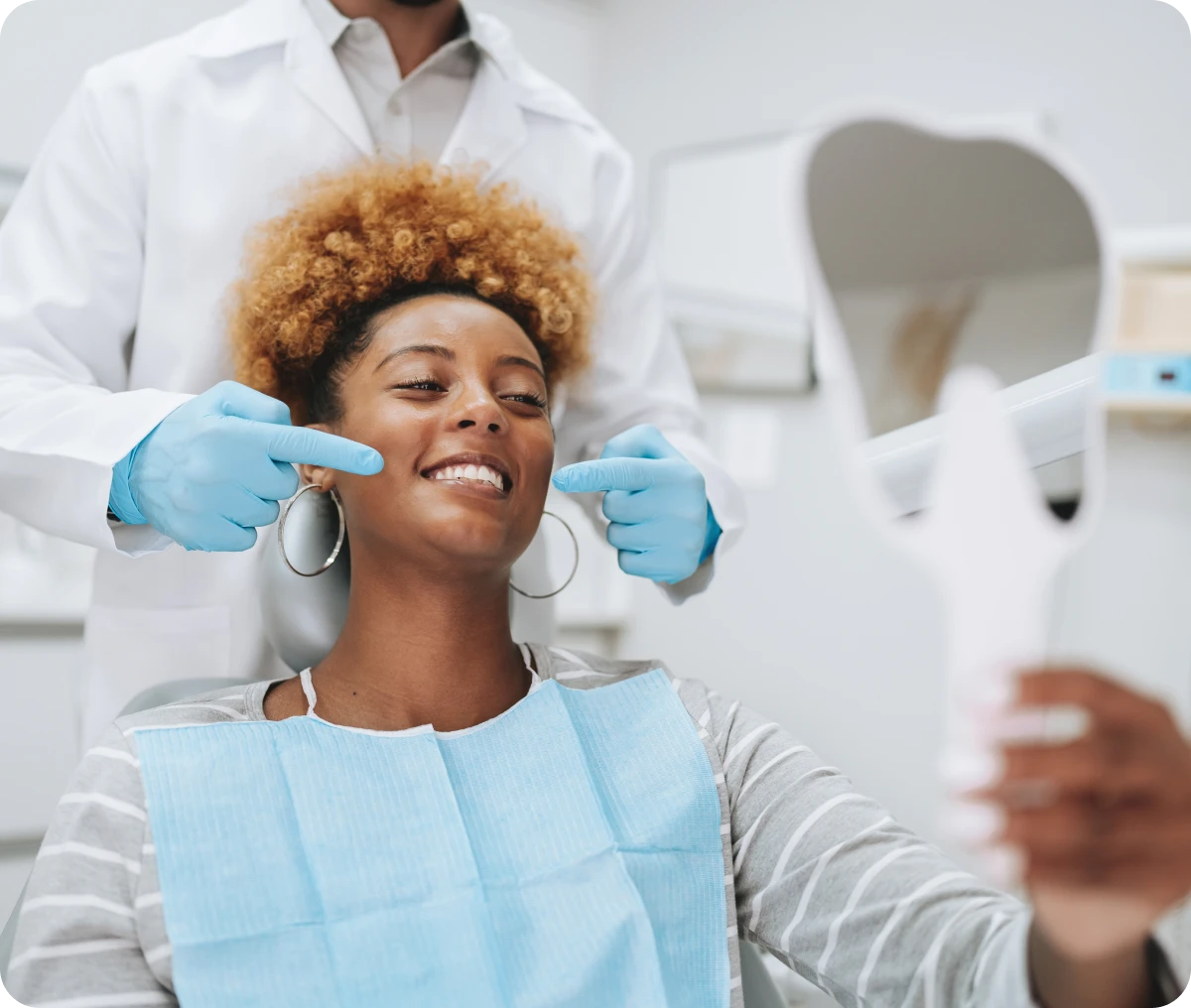 Patient smiling with dentist in clinic